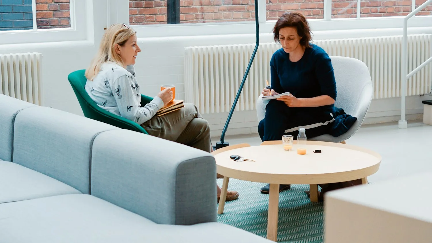 A coach in a one-on-one conversation with a client